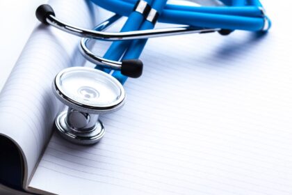 Empty prescription lying on table with stethoscope